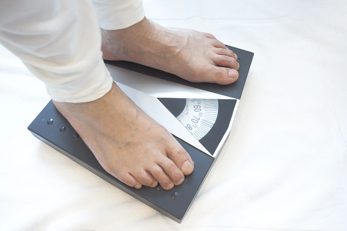 A man standing on a weighing scale 