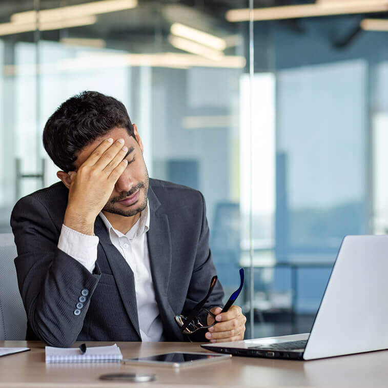 Overtired and overwhelmed businessman